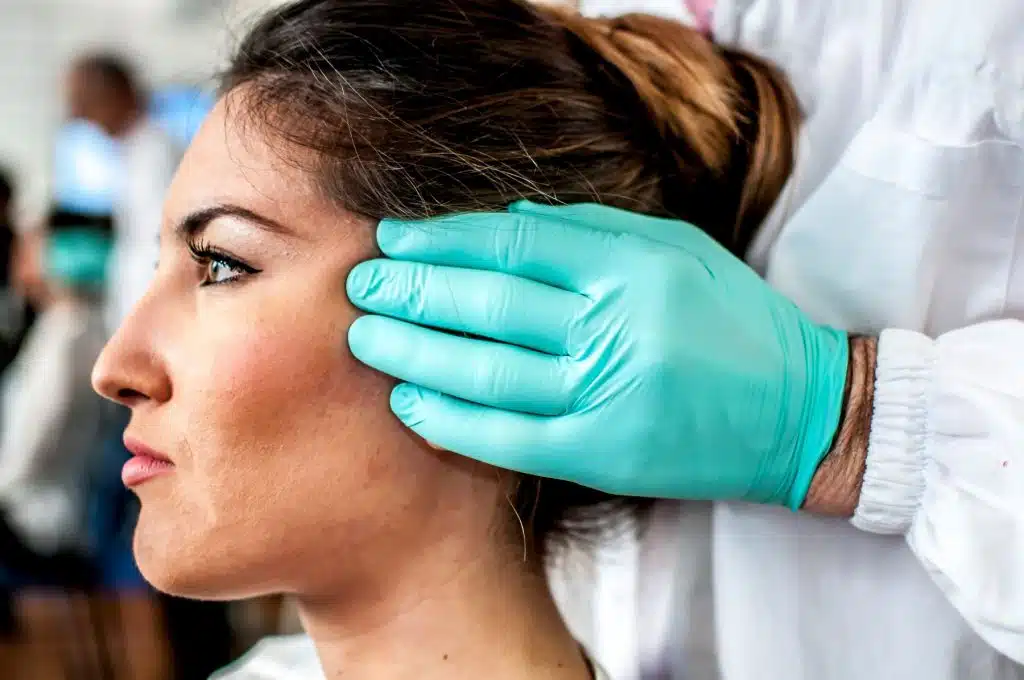 A doctor curing a bad cervical pain and headache