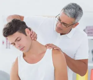 male patient receiving physical therapy treatment