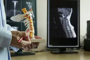 a doctor pointing at skeleton model