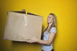 A woman carrying a big box