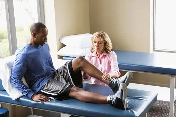 Man sitting on a clinic bed after getting a orthopedic surgery