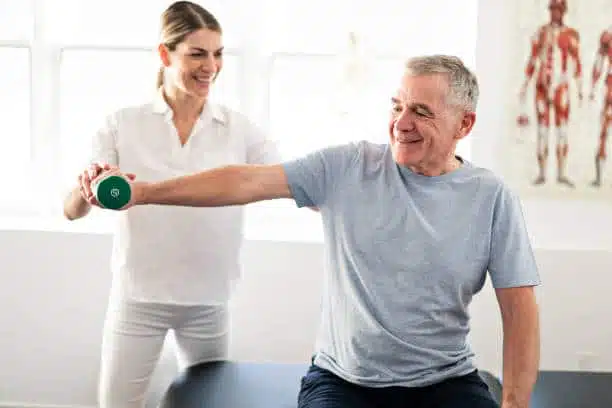 Modern rehabilitation physiotherapy worker with senior client doing some Physical therapy