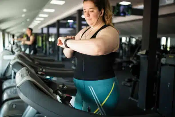 Motivated overweight women at gym exercising and losing weight as a Knee Replacement Alternatives