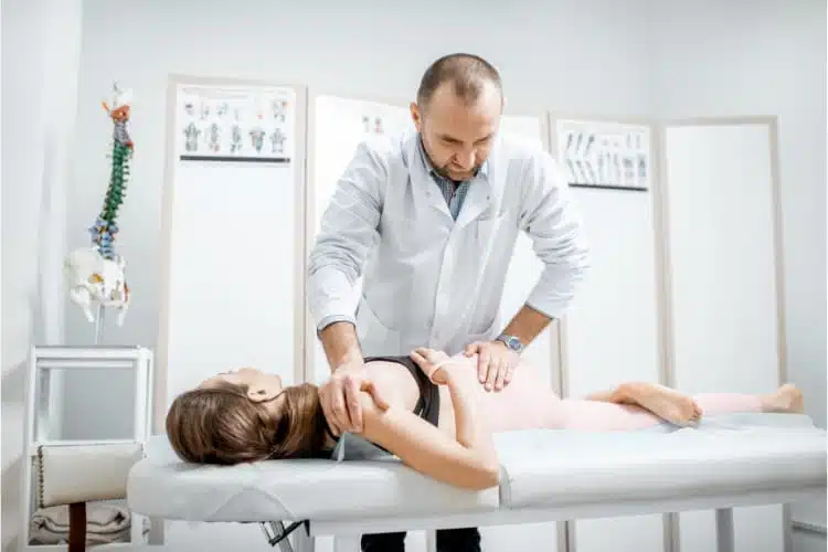 Chiropractor doing some chiropractic adjustment to the patient