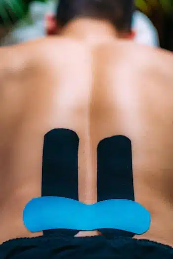 elastic kinseio tape place on mans lower back